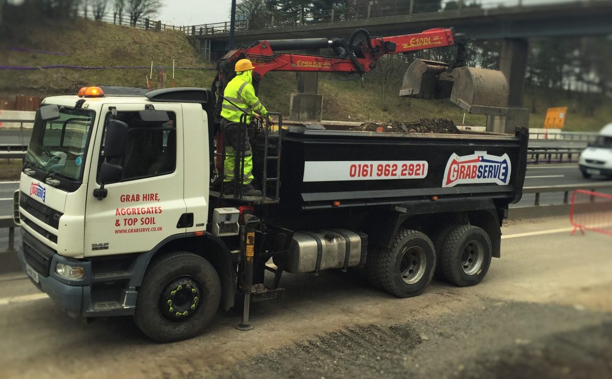 Grabserve grab wagon on motorway being loaded with aggregate