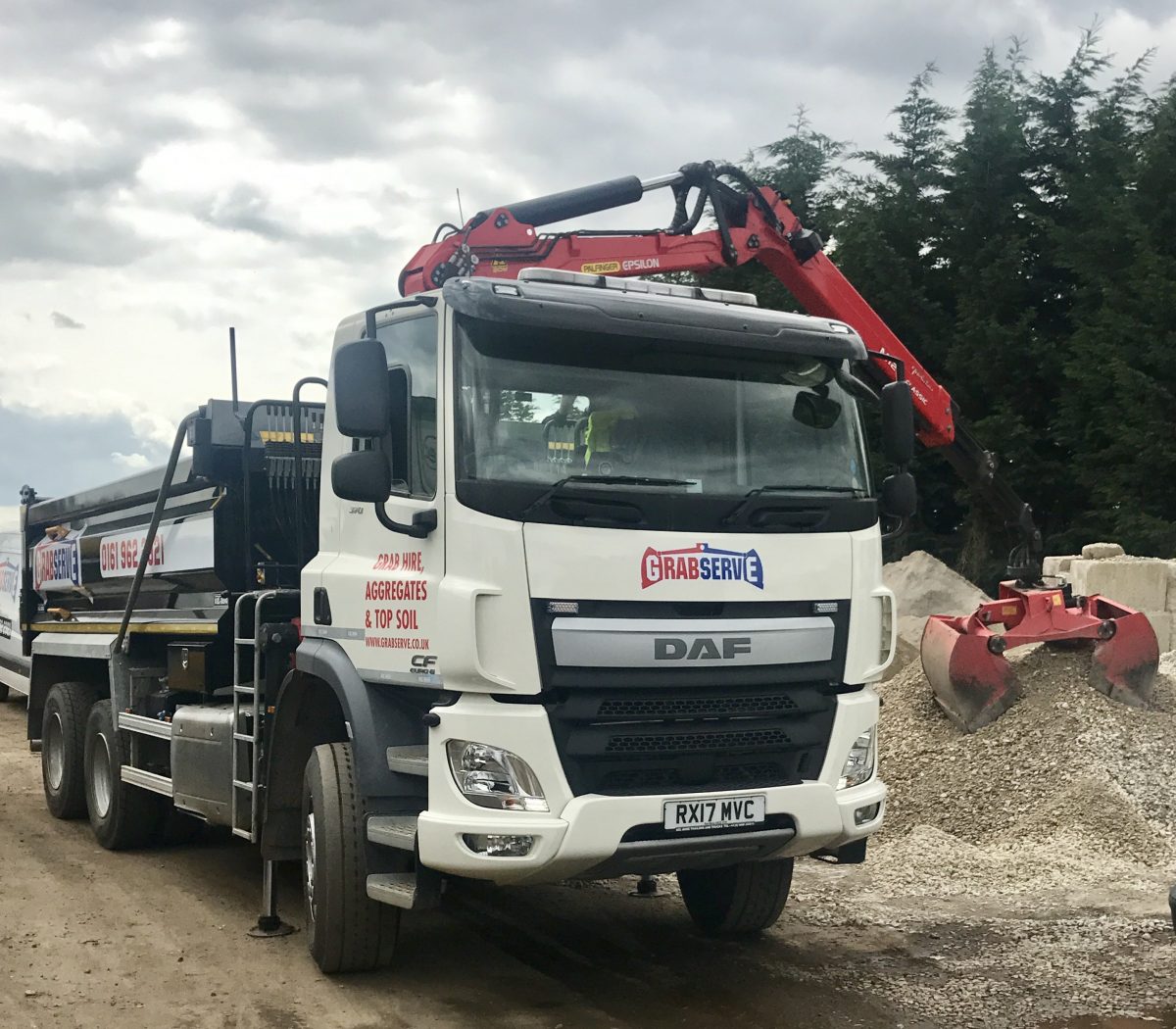 Grabserve grabber loading aggregate into into tipper